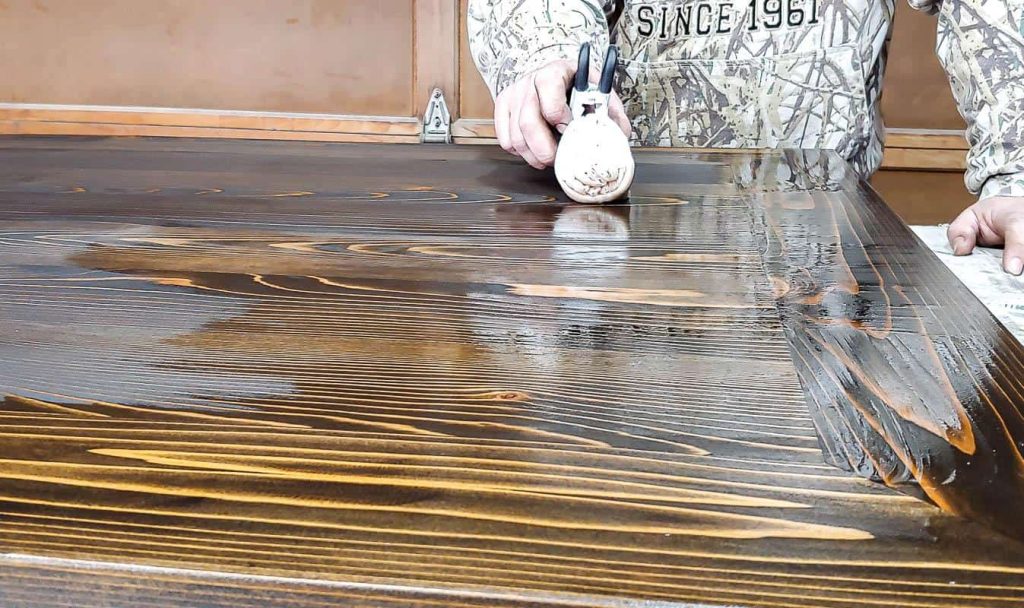 The kitchen table top is being stained and sealed to enhance its appearance and protect it from wear and tear.