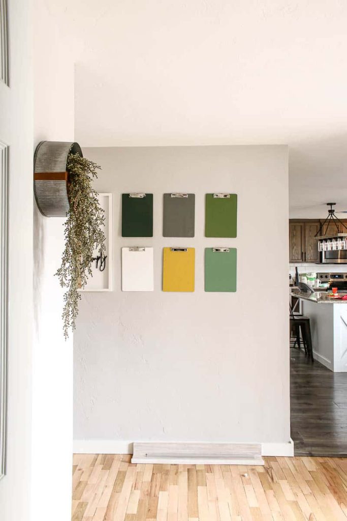 a coloful clipboard gallery wall brightens up the room