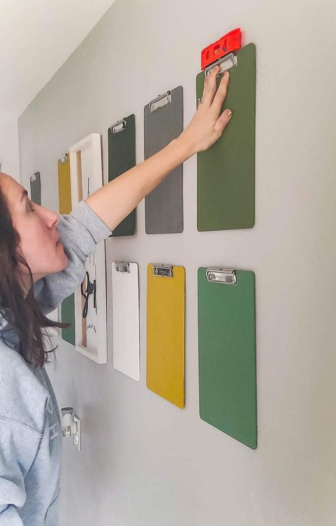 Hanging clipboards up on the wall to create a gallery wall for hanging kids art