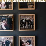 family photos hung on a gray wall in a grid pattern with overlay texts that says how to hang a grid gallery wall