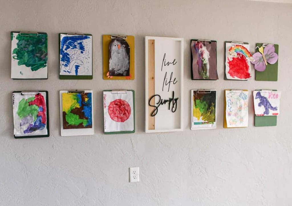 This clipboard gallery wall brightens up the room, displaying all of our son's artwork