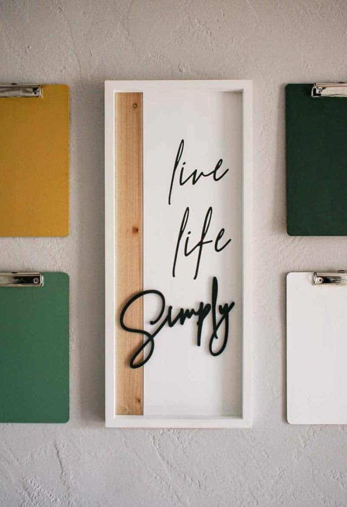 our clipboard gallery wall created around a live life simply wall art centerpiece