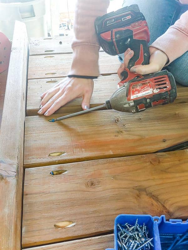 Attach slats evenly to one side, leaving a 1/4" gap, add top and bottom frames, secure the other side and mitered corners with two screws each.