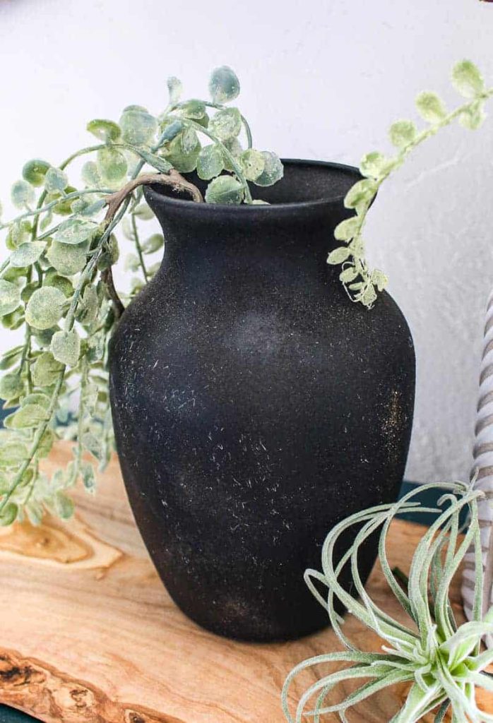 This upcycled vase looks like DIY vintage pottery after adding spray paint and dirt - it's that simple of a project!