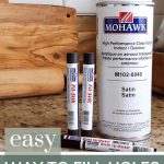 shows Mohawk products such as Fil-Stik, brush tip markers and spray can on a granite counter with text at bottom that says easy way to fill in holes in stained wood