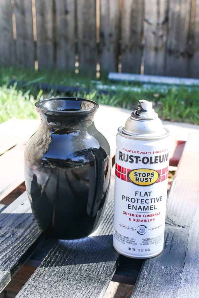 The clear glass vase has been painted with black flat protective enamel spray paint, and is ready for the next step in this upcycled vase project.