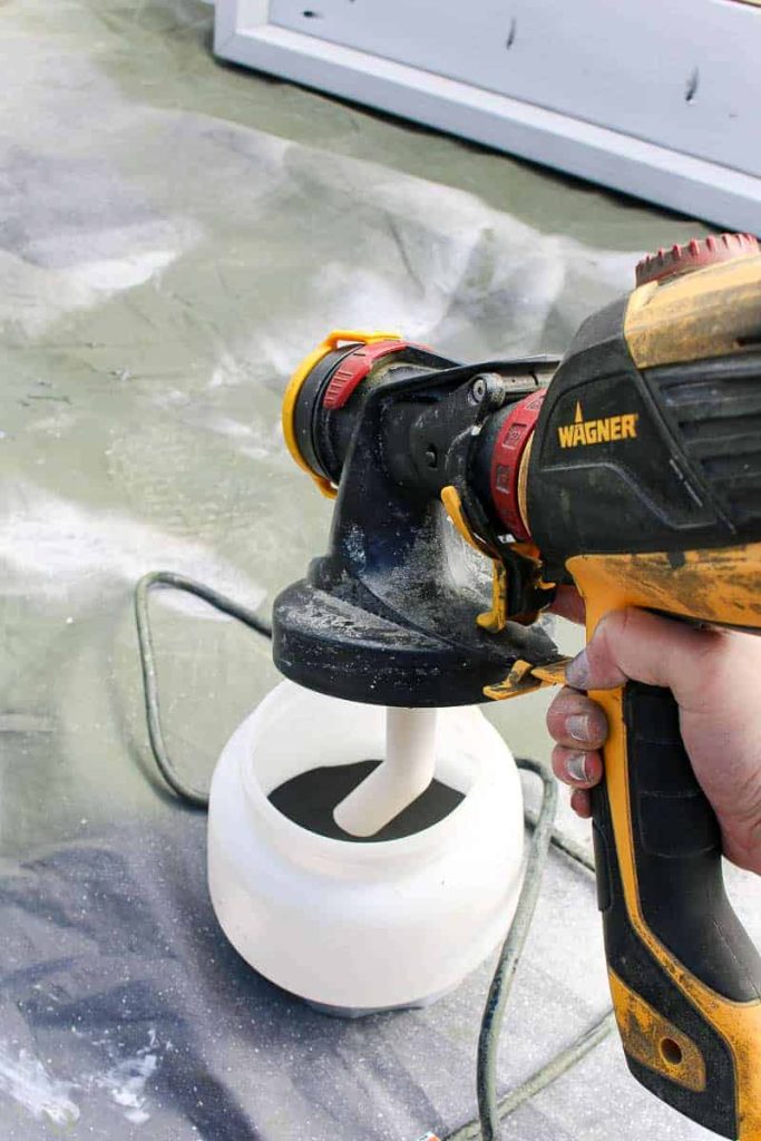 Setting up the Wagner paint sprayer, preparing to paint some furniture outdoors.