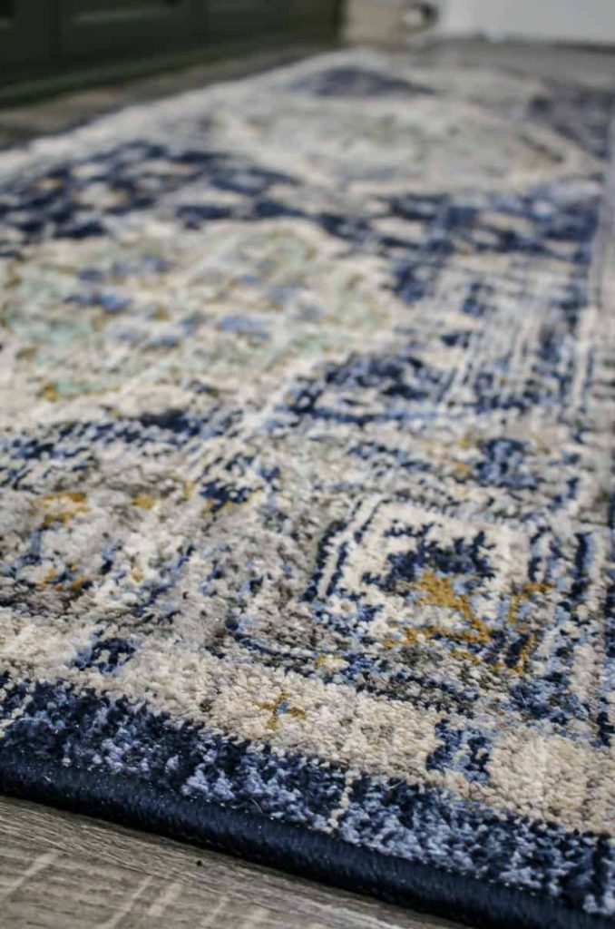A close up look at all the different colors in this bohemian style runner rug - there are shades of indigo and blue, gold, tan, and browns throughout the rug.