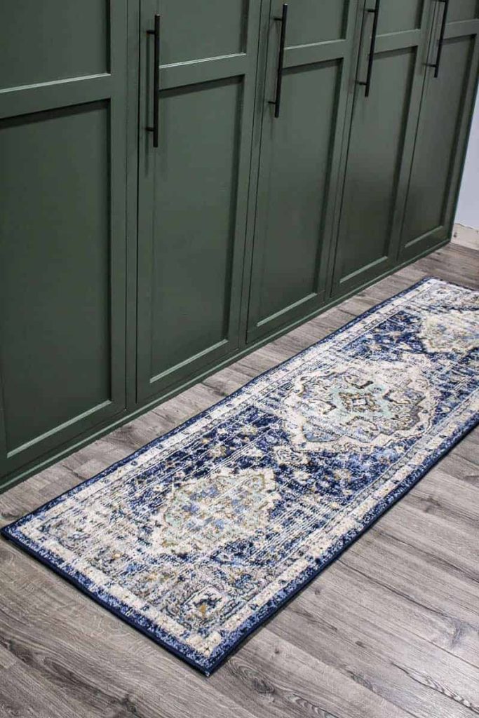 The different shades of blue in this boho style runner rug go perfectly with our hardwood floors and the hinter green color of our mudroom lockers.
