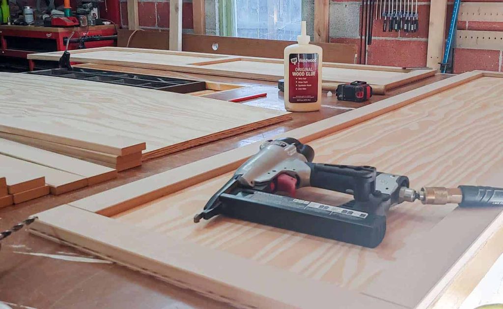 shows a table covered with locker doors and tools in the garage