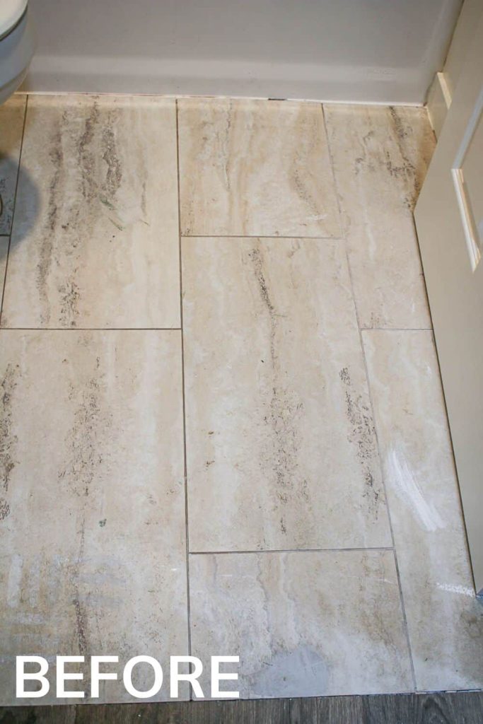 A close up view of the outdated tan tile flooring in our old guest bathroom
