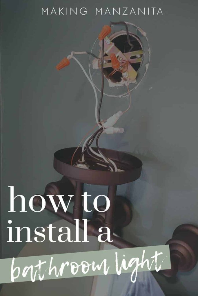 shows a vanity light wires being installed into a dark teal wall with overlay text that says how to install a bathroom light