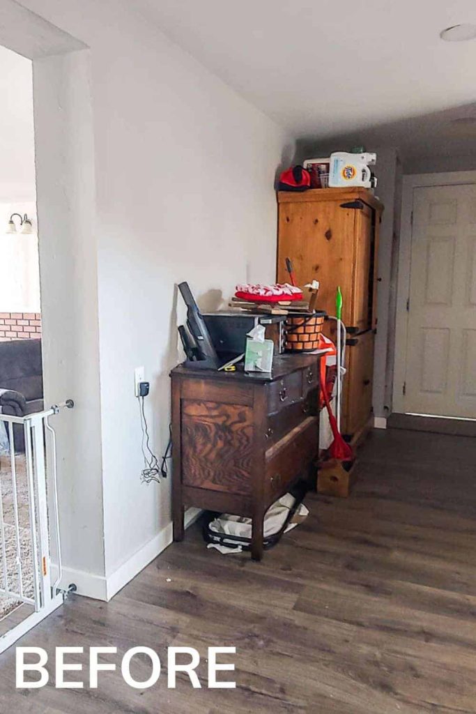 shows the back room with a dark wood cabinet and lighter wood cabinet with odds and ends of home objects