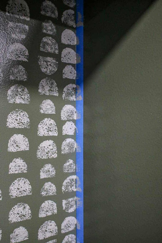 A sponge painted wall with blue painters tape
