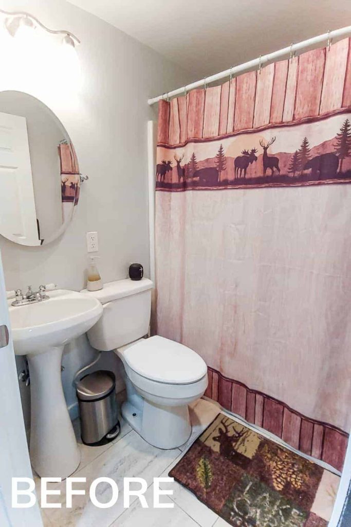 Before our budget makeover, our bathroom was a drab grey with outdated tile and accessories.