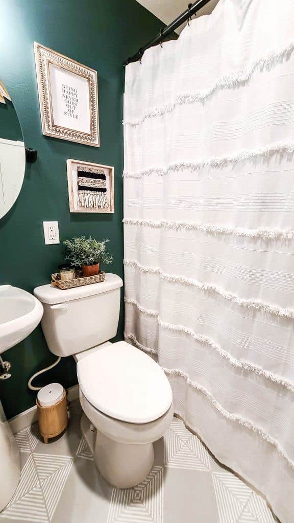 Here's how our small guest bathroom looked after our Phase 1 makeover with mostly new paint and decorations