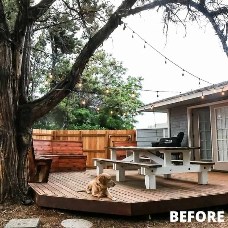 Before our cozy patio makeover, we had a small raised deck space with a picnic table, wood benches, string lights, and a fence.