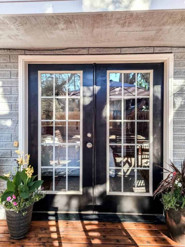 Our freshly painted double French doors that lead out to our outdoor wood patio space.