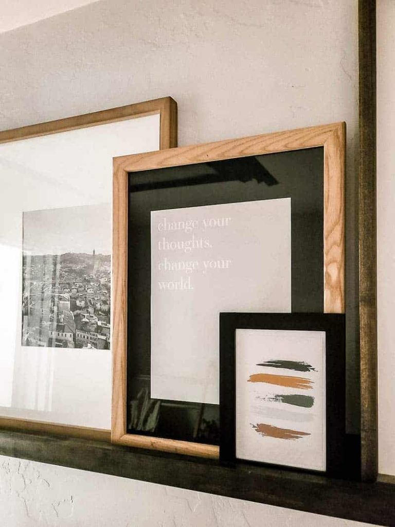 Shelf decor with frames with printable that says change your thoughts. change your world. 