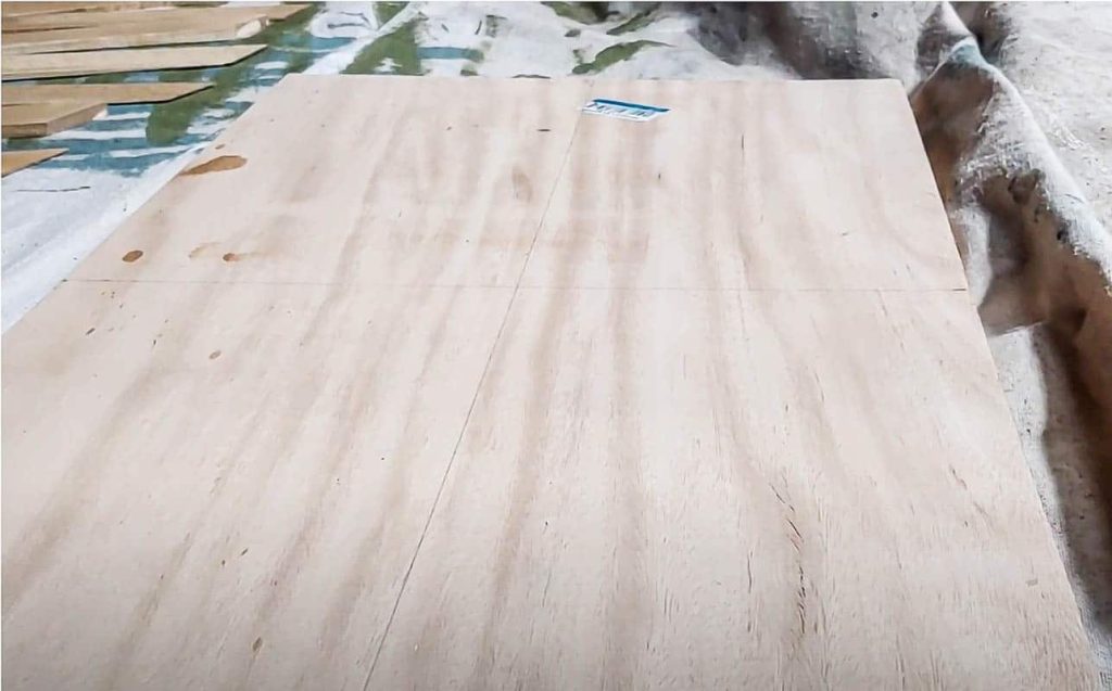 shows a piece of plywood on a drop cloth