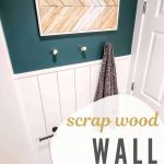 Boho wall decor with wood shim arrow pattern on wall in bathroom above towel rack with text overlay that says scrap wood wall decor