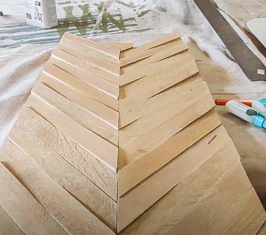 shows pieces of diagonal wood creating an arrow on the plywood