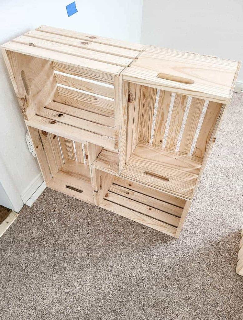 shows 4 wood crates stacked on each other on a carpet