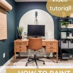 Tan painted arch on dark green blue wall with desk in front of it with leather task chair and text overlay that says how to paint arches on wall, video tutorial