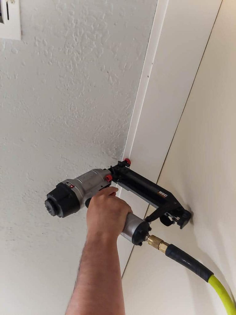 To install a shiplap ceiling, we used a nail gun to secure the shiplap planks to our popcorn ceiling.