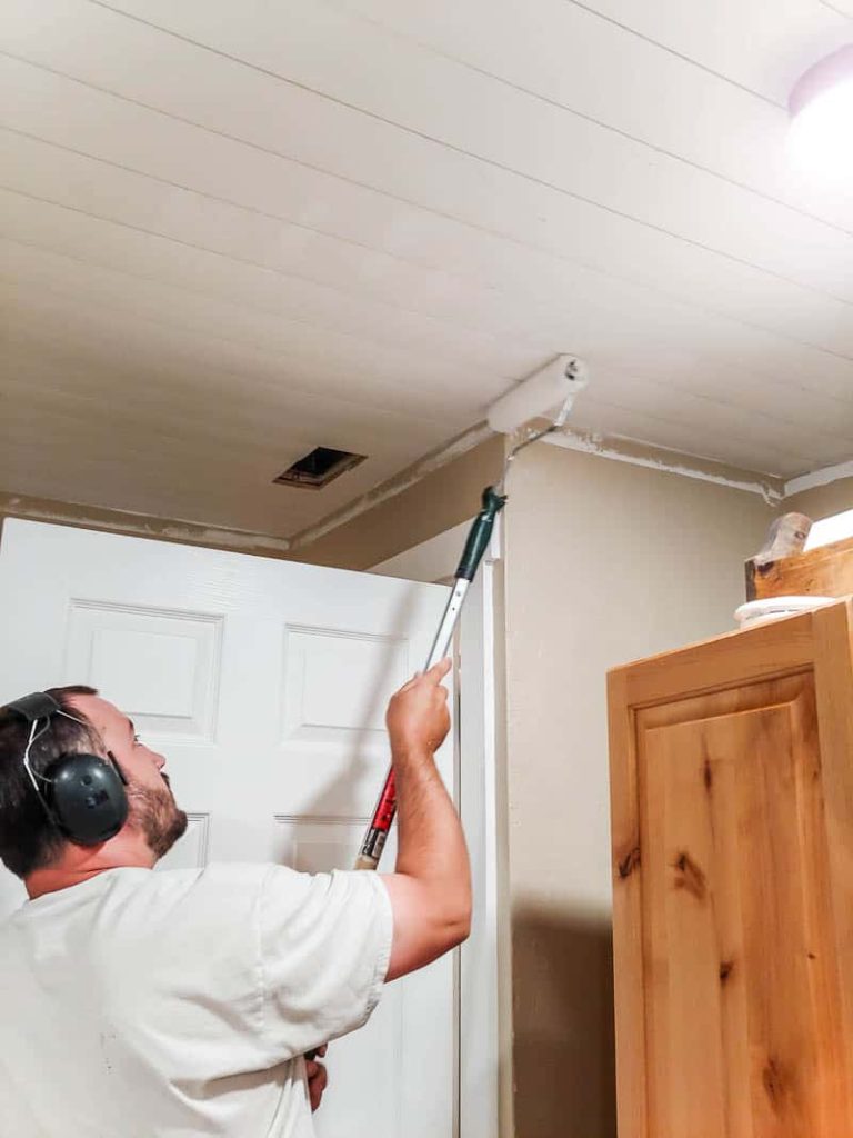 Putting the finishing touches on our newly installed shiplap ceiling with Behr's Flat White ceiling paint