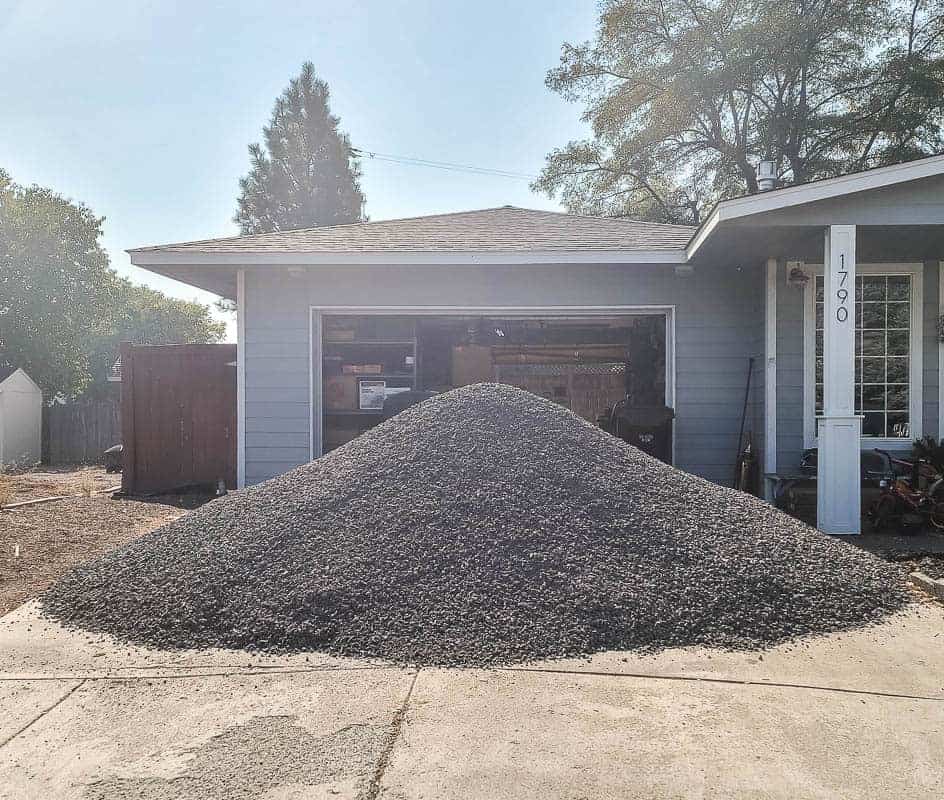 Large pile of 3/4 minus gravel in driveway