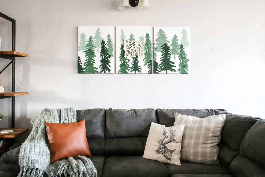 shows the ombre Christmas wall sign above a gray couch
