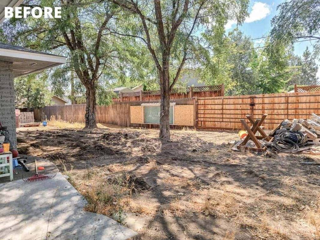 shows a before picture of the backyard with unlevel ground, dead weeks and trash