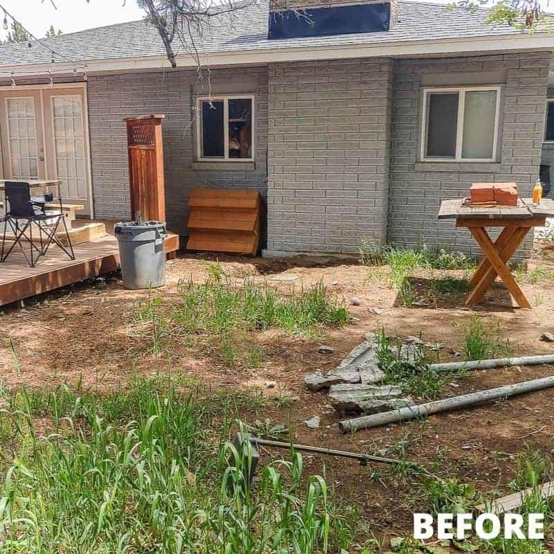 messy backyard that needs a makeover with weeds and debris laying around