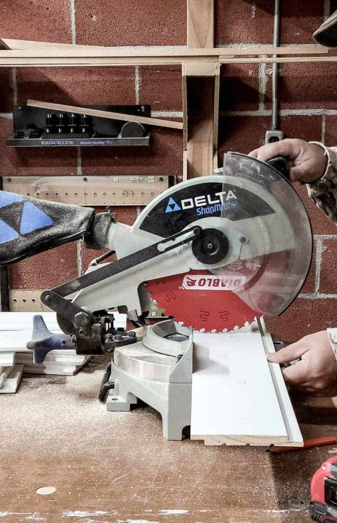 shows a man using a miter saw to cut shiplap
