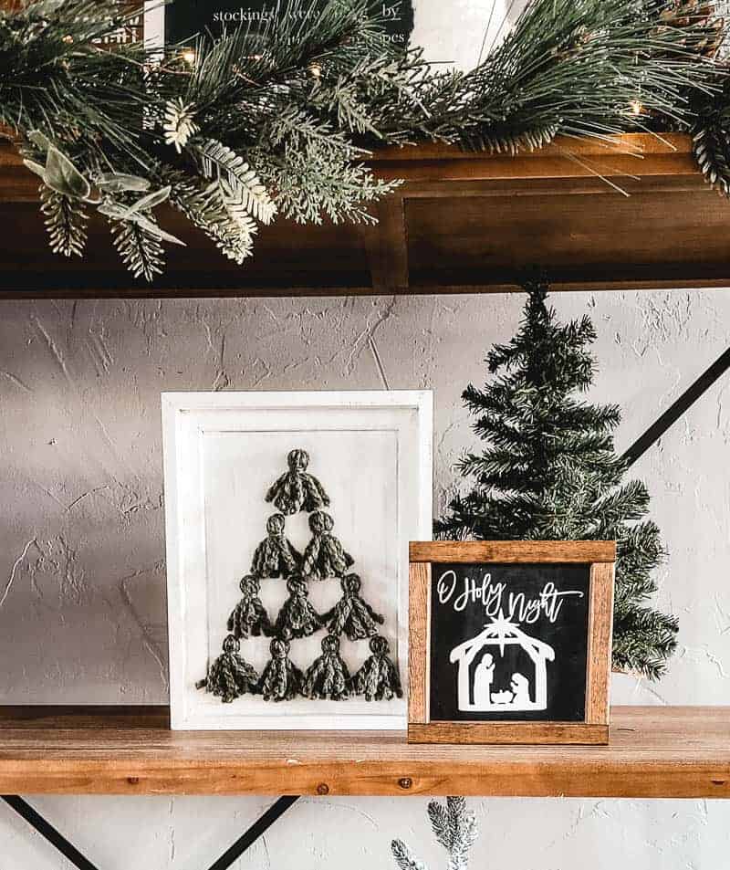 Christmas tree tassel art on shelf with small Christmas tree and O Holy Night frame