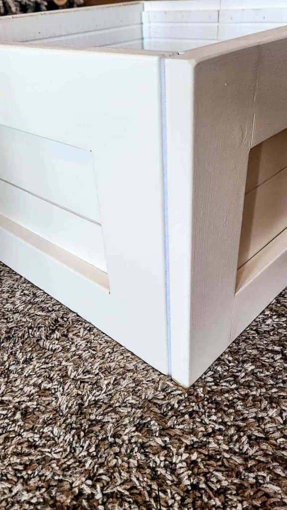 zoomed in corner detail on the shiplap christmas tree box stand with velcro on edges