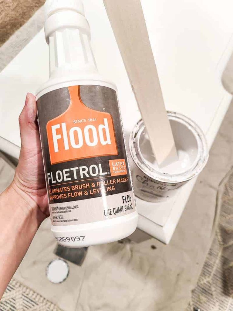 A bottle of Flood Floetrol latex based paint additive, which is supposed to help eliminate brush and roller marks when painting and repairing wood furniture.