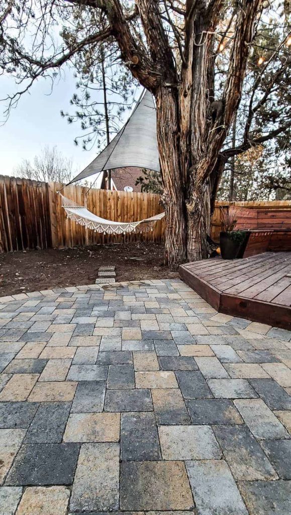 shows the paver patio and wood stained deck