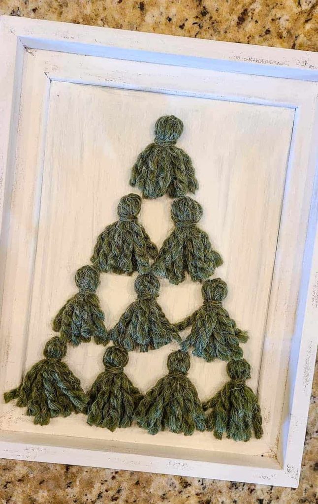 Small green Christmas tree tassels in frame