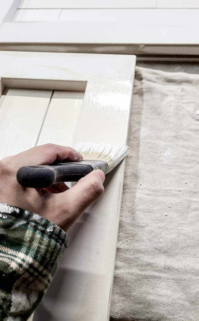shows someone painting the shiplap tree box stand