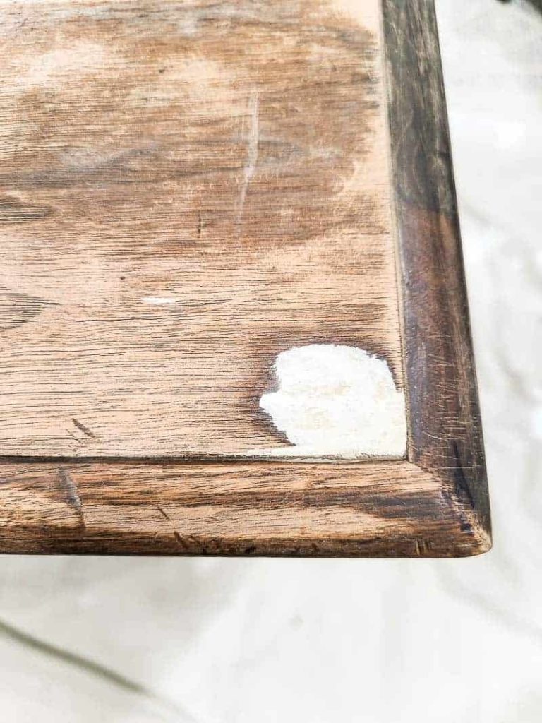 Sanded down epoxy puddy filling the damaged wood corner of a vintage wood desk.