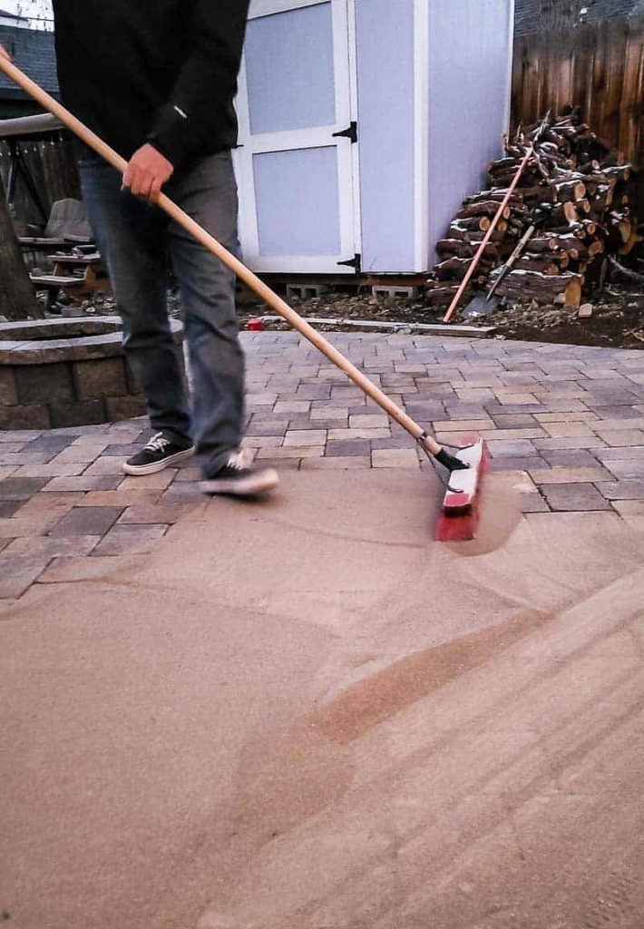 paver sand is swept across the pavers