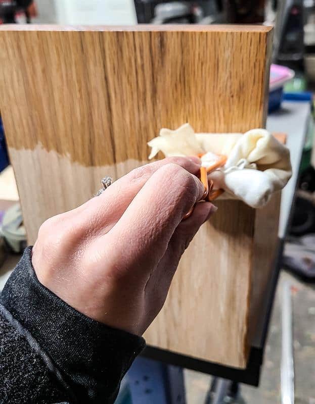 The wood is being stained to enhance its color and provide a protective finish for the desk calendar and wooden pencil holder.