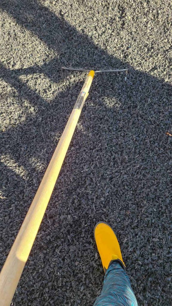 raking rubber mulch flat with garden rake