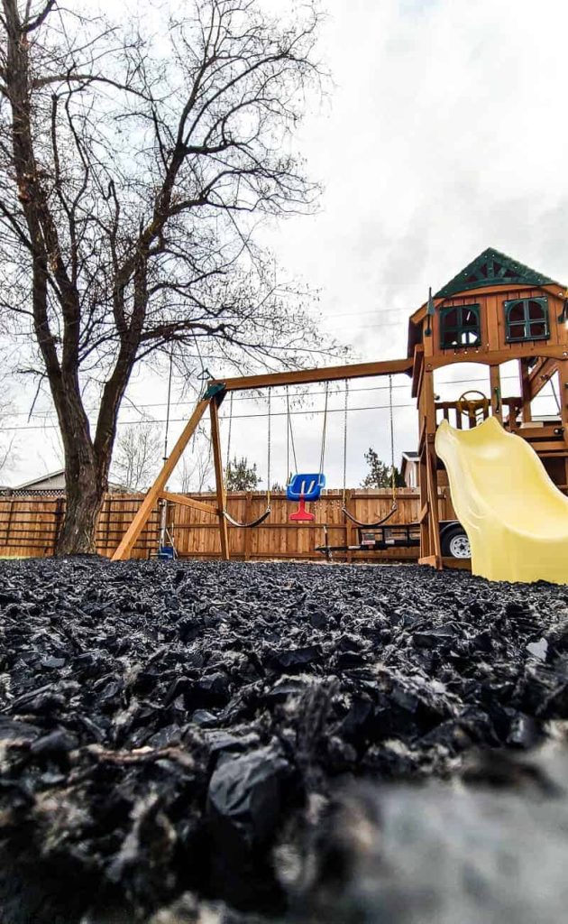 Swing set with black rubber mulch