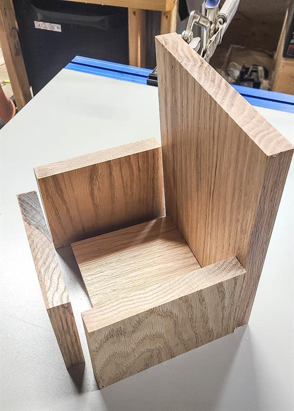 Five wooden pieces being sliced or cut.