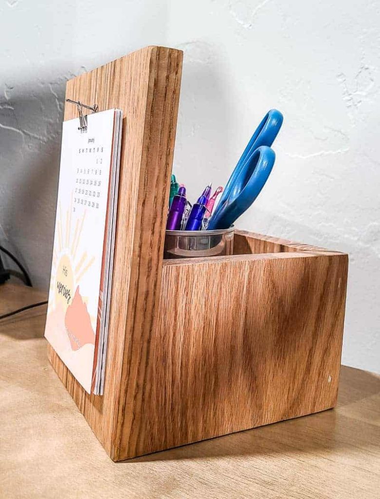 A side view of our DIY wooden desk calendar, showing the front board where the calendar is displayed, and the back box used as a pencil holder.