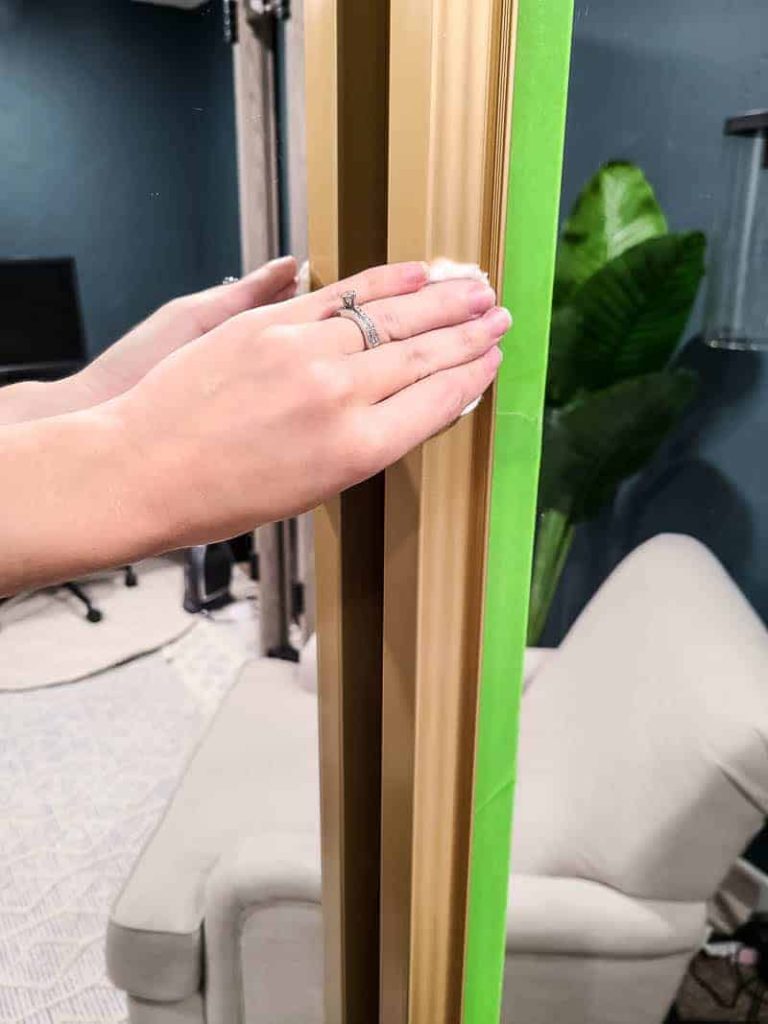 shows a hand wiping the door frame