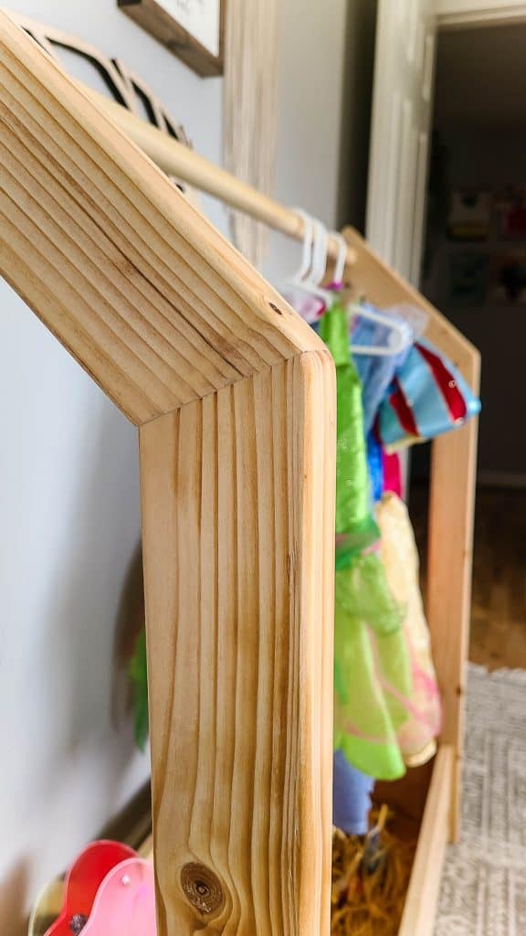 Angled corner detail of the dress up rack with house shaped ends 